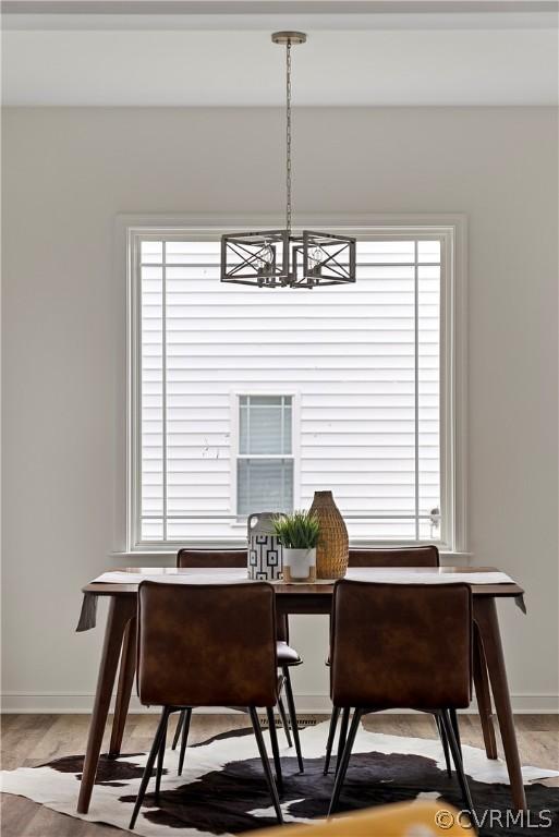 dining area featuring plenty of natural light and a notable chandelier