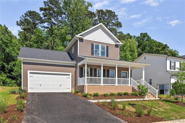 view of front of home with a front lawn, a garage, and a porch