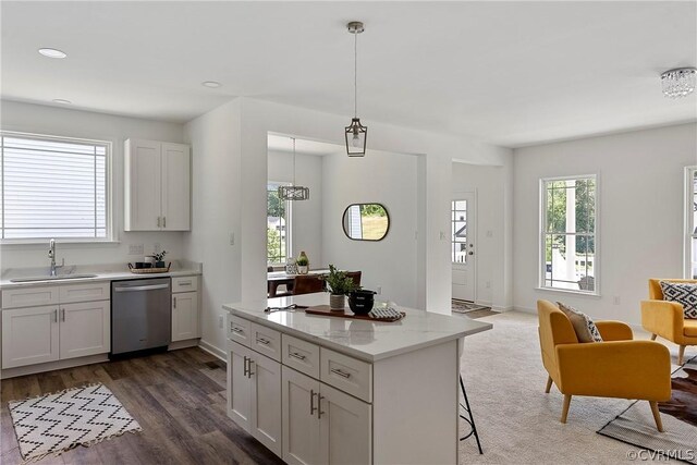 kitchen with white cabinetry, sink, pendant lighting, and dishwasher