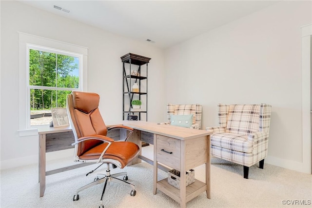 carpeted office space featuring baseboards