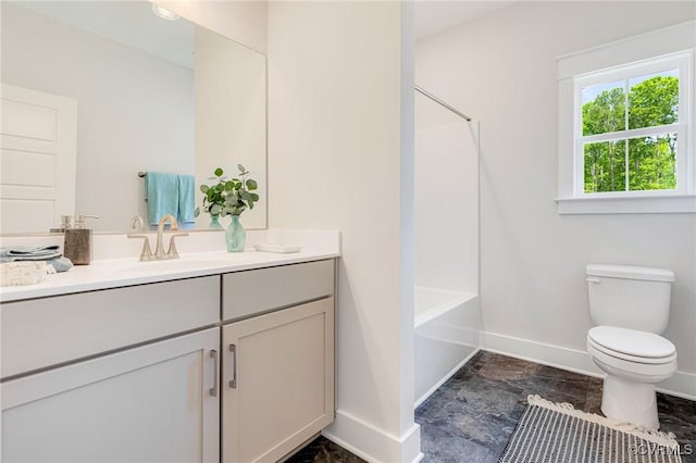 bathroom featuring baseboards, toilet, vanity, and shower / tub combination