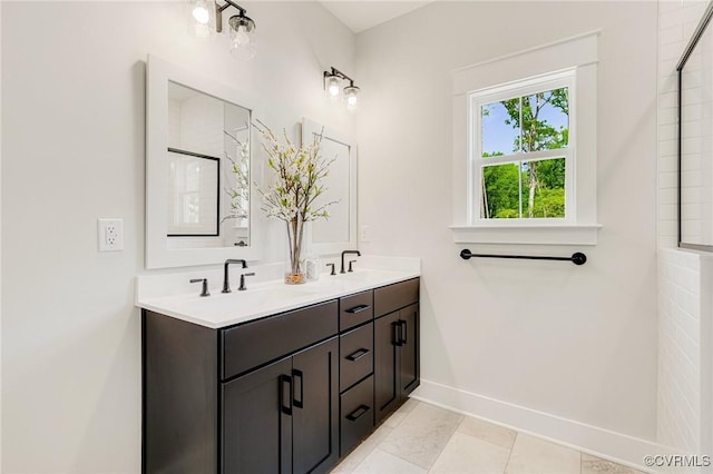 full bathroom featuring double vanity and baseboards