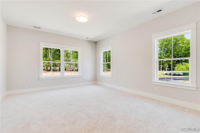 unfurnished room with baseboards and carpet