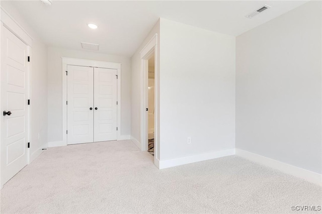unfurnished bedroom with carpet, baseboards, a closet, and recessed lighting