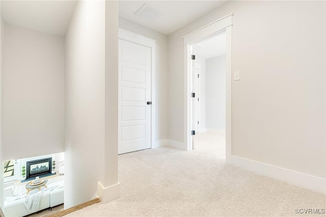 hall with carpet flooring and baseboards