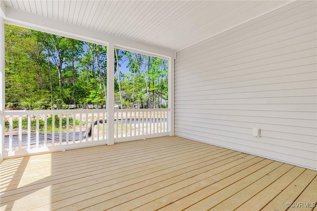 deck featuring view of wooded area