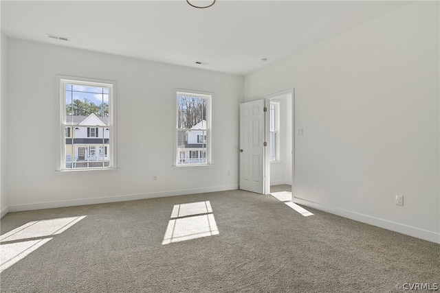 unfurnished room featuring light carpet