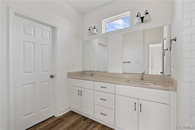 bathroom featuring dual vanity and hardwood / wood-style flooring