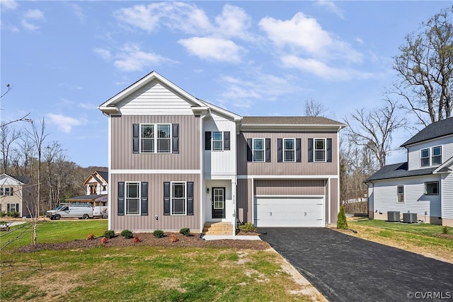 view of front facade featuring central AC, a front lawn, and a garage