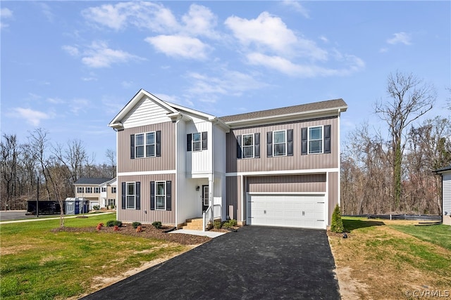 view of front of home with a front lawn and a garage