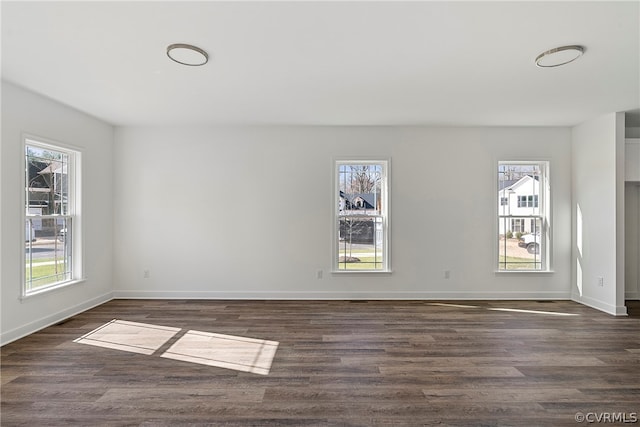 unfurnished room with dark hardwood / wood-style flooring