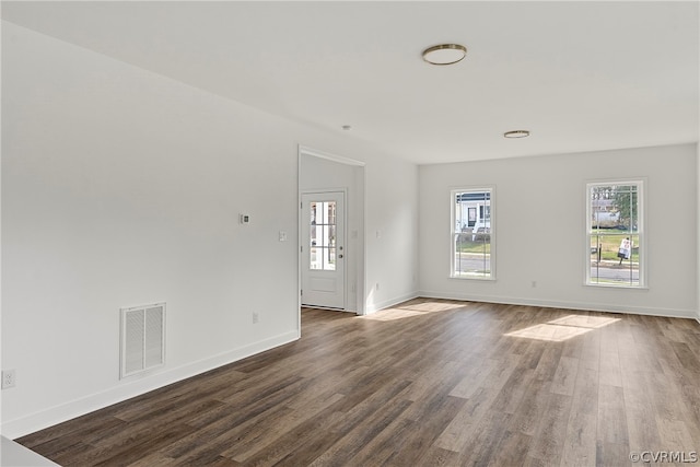 unfurnished room with dark hardwood / wood-style floors and a wealth of natural light