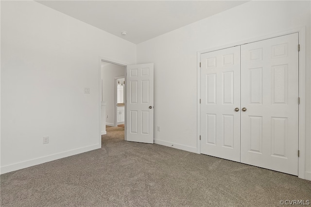 unfurnished bedroom with a closet and carpet