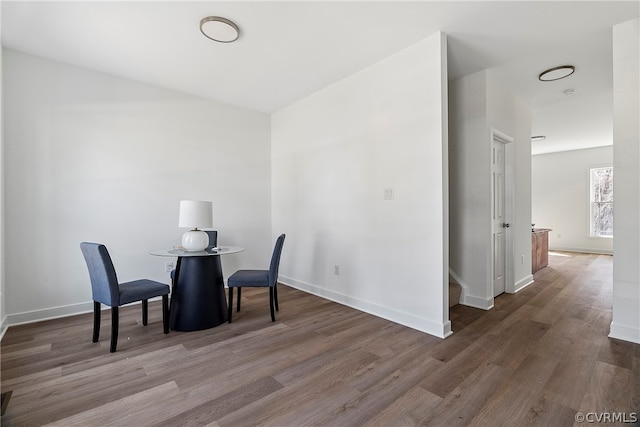 dining space with wood-type flooring