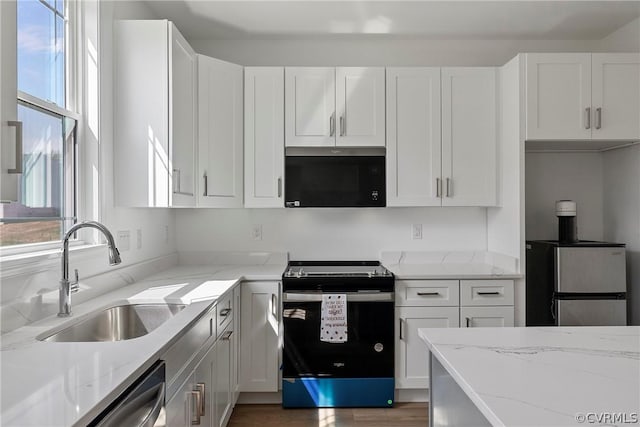 kitchen featuring a sink, white cabinets, and stainless steel appliances