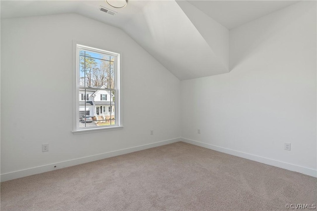 bonus room with carpet flooring, baseboards, and vaulted ceiling