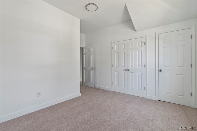 unfurnished bedroom with light colored carpet