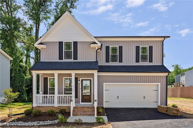 view of front of property featuring roof with shingles, covered porch, a garage, aphalt driveway, and board and batten siding