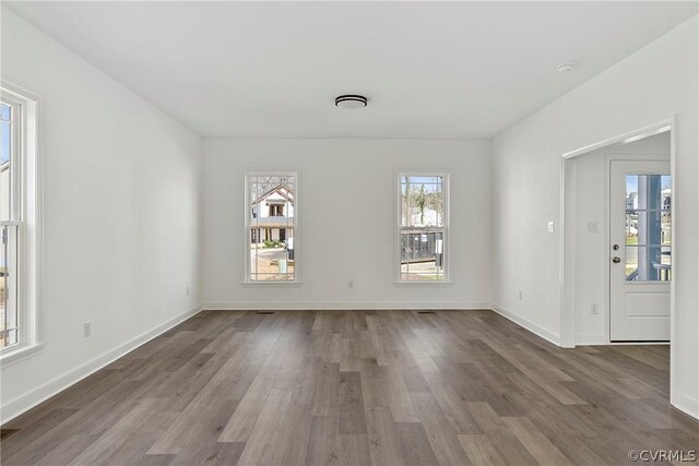 empty room with dark wood-type flooring