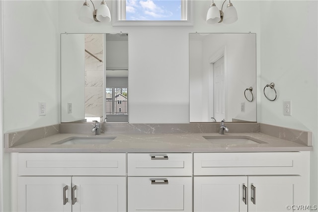 bathroom featuring plenty of natural light and double sink vanity