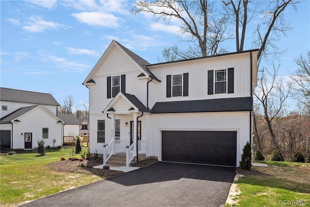 view of front of property with a front yard and a garage