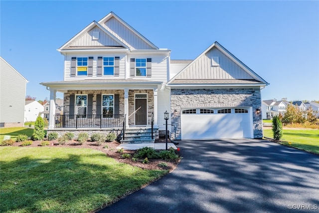 craftsman inspired home featuring a garage, a front lawn, and a porch