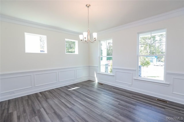 empty room featuring ornamental molding, visible vents, and dark wood finished floors