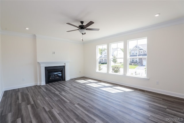 unfurnished living room with ceiling fan, crown molding, and dark hardwood / wood-style floors