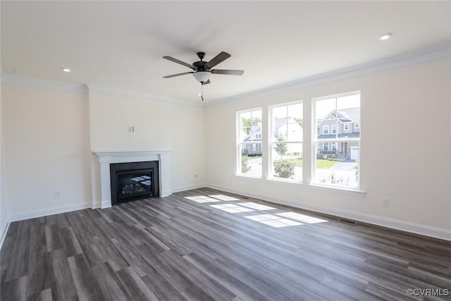 unfurnished living room with dark wood-style floors, a fireplace, baseboards, and crown molding