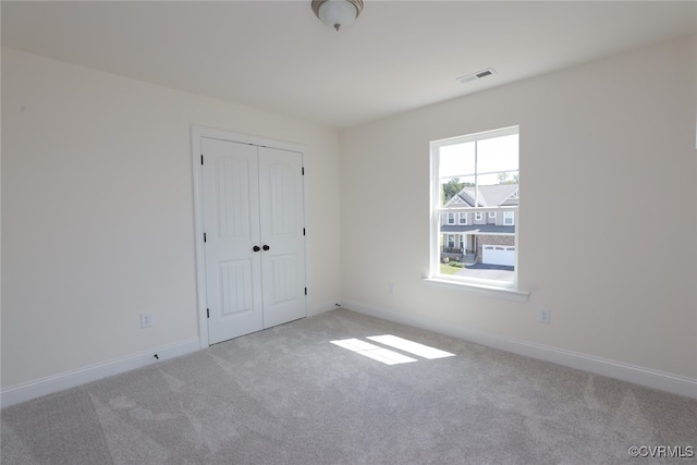 empty room featuring light carpet