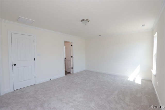 unfurnished room with carpet floors, baseboards, and crown molding