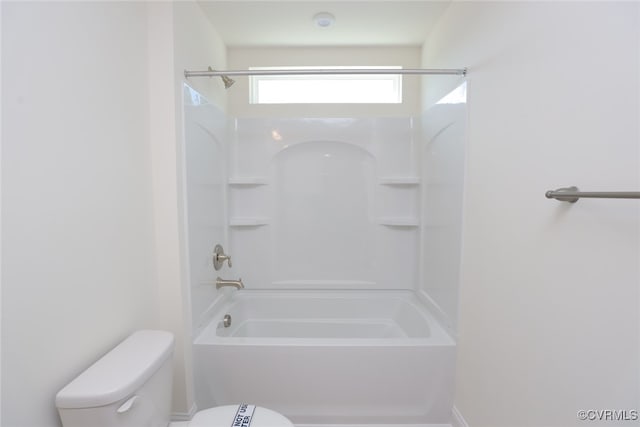 bathroom with shower / bathing tub combination and toilet