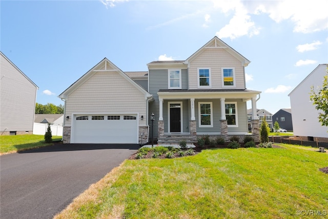 craftsman-style home with a garage, a porch, and a front yard