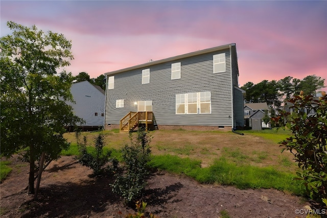 view of back house at dusk