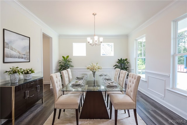 dining space featuring hardwood / wood-style flooring, crown molding, a notable chandelier, and a healthy amount of sunlight