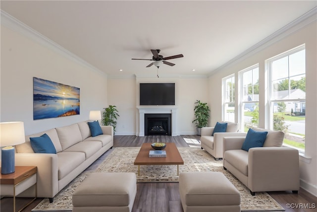 living room with ceiling fan, plenty of natural light, light hardwood / wood-style flooring, and crown molding