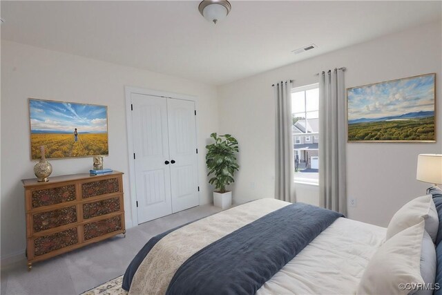 bedroom with a closet and light carpet