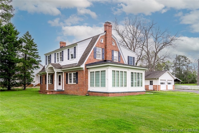 back of property with a yard and a garage