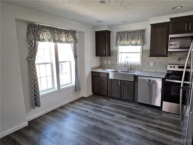 710 Wesley St, Petersburg, VA 23803 - kitchen featuring stainless steel appliances, dark brown cabinets, crown molding, and a sink