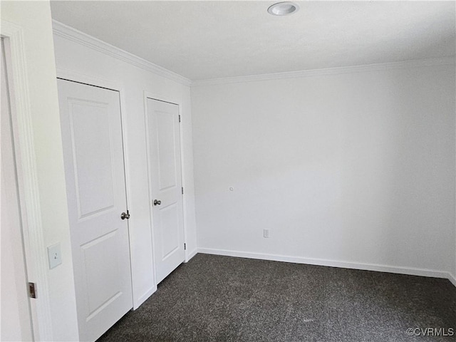710 Wesley St, Petersburg, VA 23803 - unfurnished bedroom featuring crown molding, dark carpet, and baseboards
