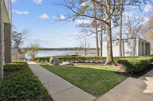 view of nearby features featuring a water view and a lawn