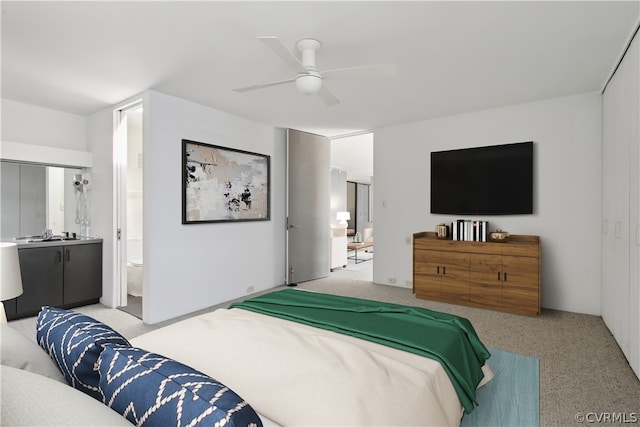 carpeted bedroom featuring ceiling fan and connected bathroom