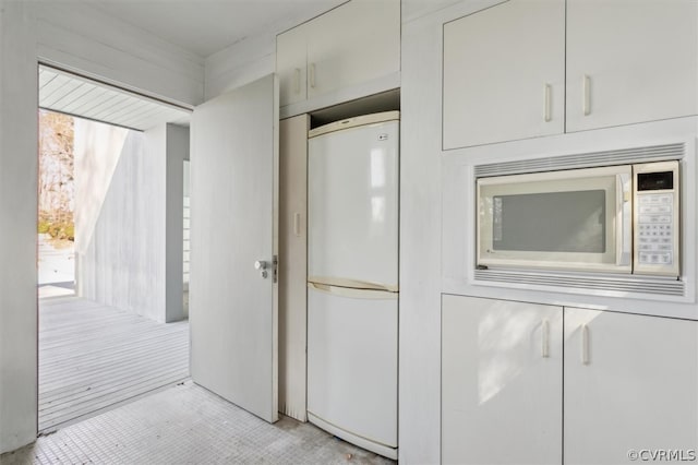 kitchen featuring white appliances and a healthy amount of sunlight