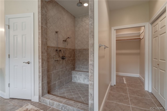 bathroom with tile patterned flooring and tiled shower