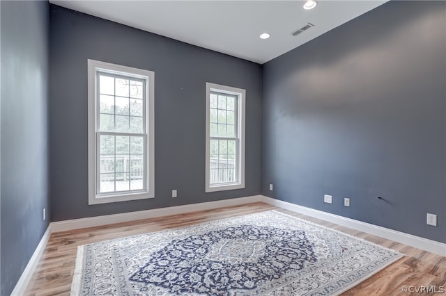 unfurnished room with wood-type flooring