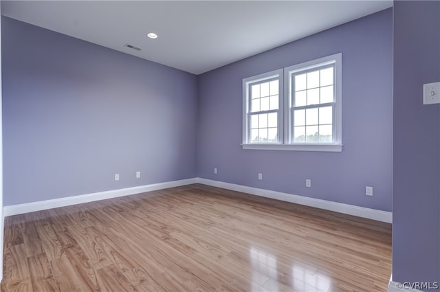 unfurnished room with light hardwood / wood-style flooring