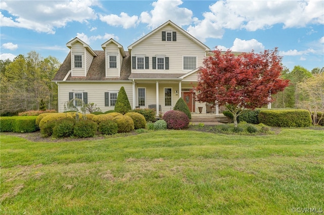 view of front facade with a front lawn and covered porch