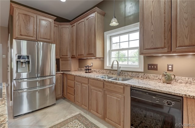 kitchen featuring black dishwasher, stainless steel refrigerator with ice dispenser, sink, light stone countertops, and light tile patterned floors