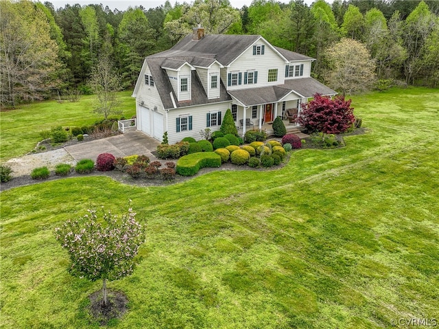 view of front of house with a porch, a front lawn, and a garage