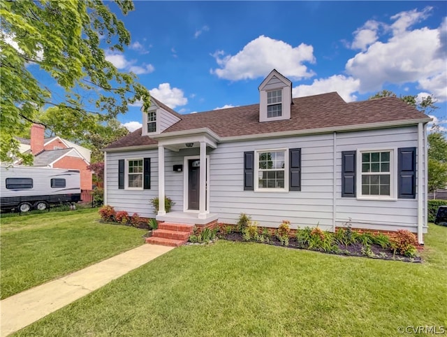 cape cod house featuring a front yard